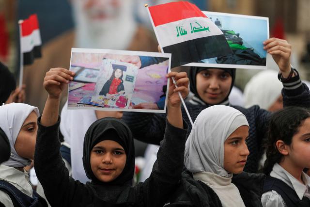 Schoolchildren participate in an anti-US and Israeli demonstration in Baghdad on March 12, 2026.. Air strikes killed at least nine Iran-backed fighters in Iraq on March 12 near the Iraqi-Syrian border, two senior security officials told AFP. The Middle East war, which was triggered on February 28 by American-Israeli attacks on Iran, is hampering the global economy's supply of oil and weakening production capacity. (Photo by AHMAD AL-RUBAYE / AFP)