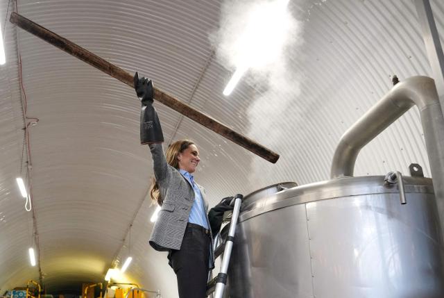 Britain's Catherine, Princess of Wales, stirs in a brewhouse kettle during a visit to the Southwark Brewing Company at the Bermondsey Beer Mile in London on March 12, 2026. (Photo by Kin Cheung / POOL / AFP)