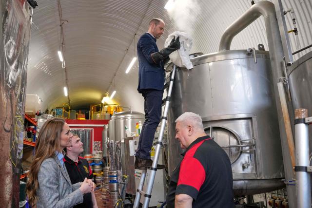 Britain's Prince William, Prince of Wales puts malt in a brewhouse kettle during a visit to the Southwark Brewing Company at the Bermondsey Beer Mile in London on March 12, 2026. (Photo by Kin Cheung / POOL / AFP)