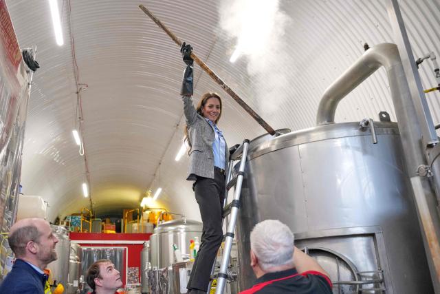 Britain's Catherine, Princess of Wales, stirs in a brewhouse kettle during a visit to the Southwark Brewing Company at the Bermondsey Beer Mile in London on March 12, 2026. (Photo by Kin Cheung / POOL / AFP)
