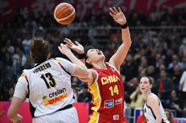China's Yueru Li (R) and Belgium's Kyara Linskens compete for the ball during the FIBA Women's Basketball World Cup 2026 qualifying tournament match between China and Belgium in Wuhan, in China's central Hubei province on March 12, 2026. (Photo by CN-STR / AFP) / China OUT
