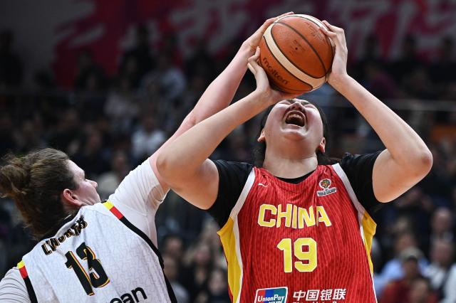 China's Ziyu Zhang (R) and Belgium's Kyara Linskens compete for the ball during the FIBA Women's Basketball World Cup 2026 qualifying tournament match between China and Belgium in Wuhan, in China's central Hubei province on March 12, 2026. (Photo by CN-STR / AFP) / China OUT