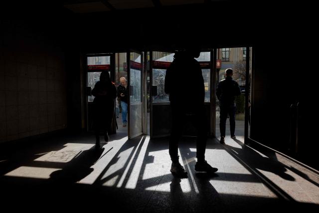 People enter the subway in Kyiv on March 12, 2026, amid the Russian invasion of Ukraine. (Photo by Tetiana DZHAFAROVA / AFP)
