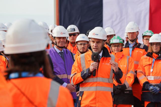 France's President Emmanuel Macron (C) speaks during a visit at the EPR2 new generation reactors construction site at the Penly nuclear power plant in Petit-Caux on the English channel coast on March 12, 2026. The nuclear recovery program announced in 2022 by France's President Emmanuel Macron provides for the construction of 6 new generation reactors known as EPR2, built in three pairs, at Penly, Gravelines and then at Bugey. (Photo by Ludovic MARIN / POOL / AFP)