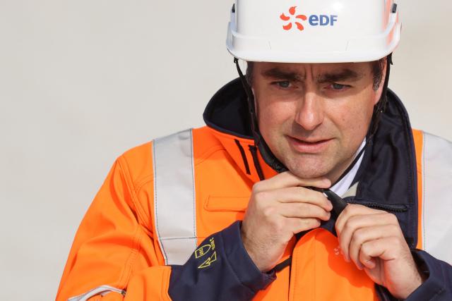 France's Prime Minister Sebastien Lecornu adjusts his helmet during a visit of the EPR2 new generation reactors construction site at the Penly nuclear power plant in Petit-Caux on the English channel coast on March 12, 2026. The nuclear recovery program announced in 2022 by France's President Emmanuel Macron provides for the construction of 6 new generation reactors known as EPR2, built in three pairs, at Penly, Gravelines and then at Bugey. (Photo by Ludovic MARIN / POOL / AFP)