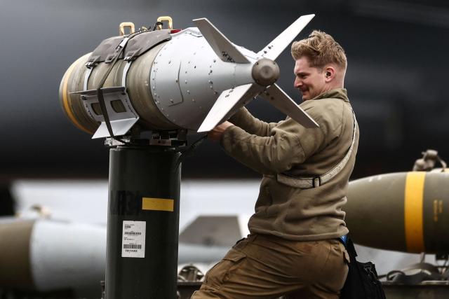 USAF military ground personnel prepare Joint Direct Attack Munitions (JDAM) for a US Air Force (USAF) B-1 Lancer bomber on the tarmac at RAF Fairford in south-west England on March 12, 2026. Fairford is one of two bases, along with the Diego Garcia facility in the Indian Ocean, that the UK has given the US permission to use for "specific defensive operations into Iran" to destroy Iranian missiles at source, the British defence minister said in a statement. (Photo by Henry NICHOLLS / AFP)