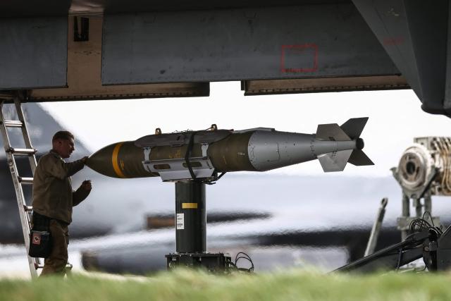 USAF military ground personnel prepare Joint Direct Attack Munitions (JDAM) for a US Air Force (USAF) B-1 Lancer bomber on the tarmac at RAF Fairford in south-west England on March 12, 2026. Fairford is one of two bases, along with the Diego Garcia facility in the Indian Ocean, that the UK has given the US permission to use for "specific defensive operations into Iran" to destroy Iranian missiles at source, the British defence minister said in a statement. (Photo by Henry NICHOLLS / AFP)