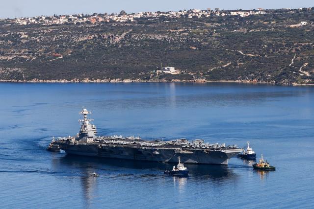 (FILES) The US Navy aircraft carrier USS Gerald R. Ford departs Souda Bay on the island of Crete on February 26, 2026. Two crew on the USS Gerald R. Ford -- the world's largest aircraft carrier currently deployed for the war against Iran -- were injured on March 12, 2026, in a laundry room fire, the US Navy said. "Two sailors are currently receiving medical treatment for non-life-threatening injuries and are in stable condition," a statement from US Naval Forces Central Command said. The Navy said the fire, originating "in the ship's main laundry," was "not combat-related and is contained." (Photo by Costas METAXAKIS / AFP)