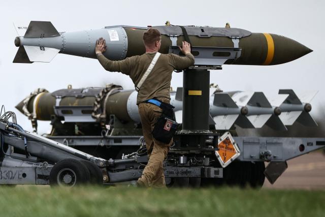 USAF military ground personnel prepare Joint Direct Attack Munitions (JDAM) for a US Air Force (USAF) B-1 Lancer bomber on the tarmac at RAF Fairford in south-west England on March 12, 2026. Fairford is one of two bases, along with the Diego Garcia facility in the Indian Ocean, that the UK has given the US permission to use for "specific defensive operations into Iran" to destroy Iranian missiles at source, the British defence minister said in a statement. (Photo by Henry Nicholls / AFP)