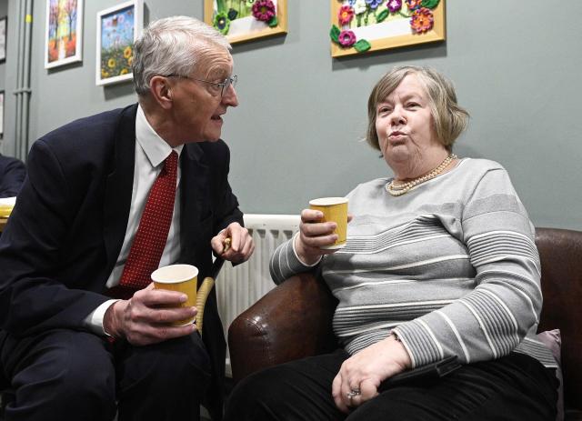 Britain's Northern Ireland Secretary Hilary Benn (L) reacts during a visit to the Atlas Women's centre in Lisburn, Northern Ireland, on March 12, 2026, where he met with members of the local community. (Photo by Mark Marlow / POOL / AFP)