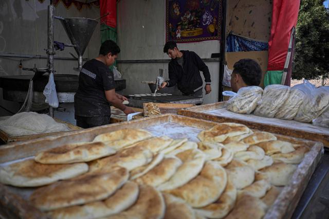 An Egyptian baker makes Qatayef, traditional pancakes made during the Muslim holy fasting month of Ramadan, at his shop in Cairo on March 12, 2026. Muslims throughout the world are marking the month of Ramadan, the holiest month in the Islamic calendar, during which devotees fast from dawn until dusk. (Photo by Khaled DESOUKI / AFP)