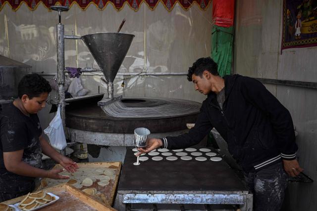 An Egyptian baker makes Qatayef, traditional pancakes made during the Muslim holy fasting month of Ramadan, at his shop in Cairo on March 12, 2026. Muslims throughout the world are marking the month of Ramadan, the holiest month in the Islamic calendar, during which devotees fast from dawn until dusk. (Photo by Khaled DESOUKI / AFP)