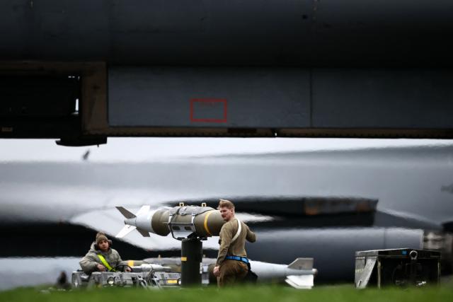 USAF military ground personnel prepare Joint Direct Attack Munitions (JDAM) for a US Air Force (USAF) B-1 Lancer bomber jet on the tarmac at RAF Fairford in south-west England on March 12, 2026. Fairford is one of two bases, along with the Diego Garcia facility in the Indian Ocean, that the UK has given the US permission to use for "specific defensive operations into Iran" to destroy Iranian missiles at source, the British defence minister said in a statement. (Photo by Henry NICHOLLS / AFP)