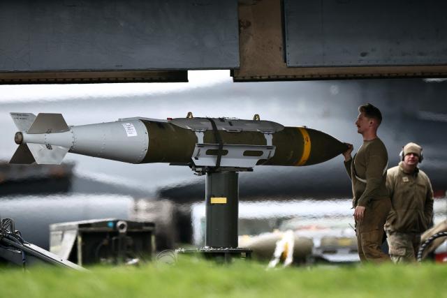 USAF military ground personnel prepare Joint Direct Attack Munitions (JDAM) for a US Air Force (USAF) B-1 Lancer bomber jet on the tarmac at RAF Fairford in south-west England on March 12, 2026. Fairford is one of two bases, along with the Diego Garcia facility in the Indian Ocean, that the UK has given the US permission to use for "specific defensive operations into Iran" to destroy Iranian missiles at source, the British defence minister said in a statement. (Photo by Henry NICHOLLS / AFP)