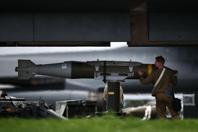 USAF military ground personnel prepare Joint Direct Attack Munitions (JDAM) for a US Air Force (USAF) B-1 Lancer bomber jet on the tarmac at RAF Fairford in south-west England on March 12, 2026. Fairford is one of two bases, along with the Diego Garcia facility in the Indian Ocean, that the UK has given the US permission to use for "specific defensive operations into Iran" to destroy Iranian missiles at source, the British defence minister said in a statement. (Photo by Henry NICHOLLS / AFP)