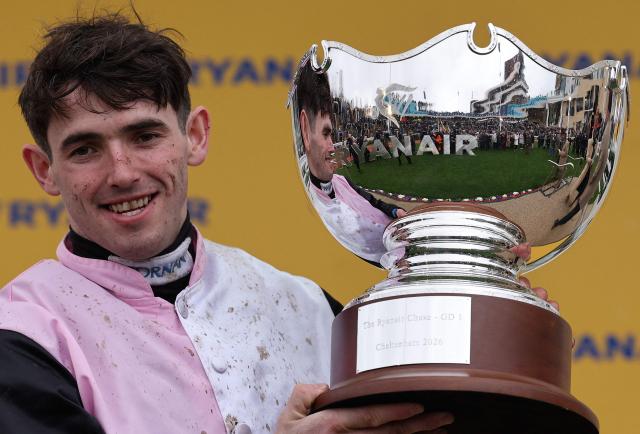 Jockey Darragh O'Keefe celebrates with the trophy after riding racehorse Heart Wood to win the Ryanair Chase (The Festival Trophy) horse race on the third day of the Cheltenham Festival at Cheltenham Racecourse, in Cheltenham, western England on March 12, 2026. (Photo by Adrian Dennis / AFP)