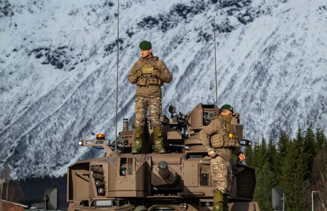 Members of the 1st Foreign Cavalry Regiment (1er REC) stand on a Jaguar Armoured Recce Combat Vehicle during a demonstration near Setermoen on March 12, 2026, as NATO conducts its Cold Response military exercise. The Norwegian-led winter exercise involves 32.000 troops, 100 aircraft, and 30 warships from 14 nations taking part in high intensity, multi-domain operations in an arctic climate. (Photo by John MACDOUGALL / AFP)
