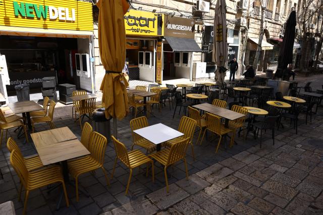 Seats remain empty at a restaurant along Jaffa Street on day 13 of the US-Israel war on Iran, in west Jerusalem on March 12, 2026. On February 28, Israel and the United States launched strikes on Iran, killing its supreme leader Ayatollah and triggering a war that spread across the Middle East. (Photo by HAZEM BADER / AFP) / 