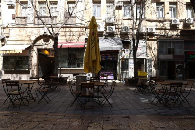 Seats remain empty at a restaurant along Jaffa Street on day 13 of the US-Israel war on Iran, in west Jerusalem on March 12, 2026. On February 28, Israel and the United States launched strikes on Iran, killing its supreme leader Ayatollah and triggering a war that spread across the Middle East. (Photo by HAZEM BADER / AFP) / 