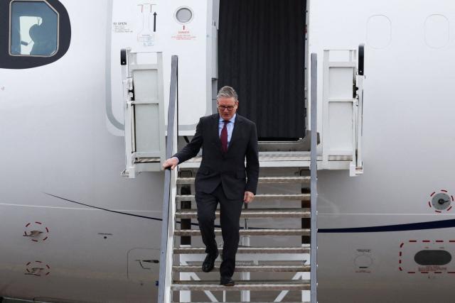 Britain's Prime Minister Keir Starmer disembarks an aircraft upon his arrival at Cork Airport in Cork, Ireland, on March 12, 2026, for a two-day UK-Ireland summit. (Photo by Cathal McNaughton / POOL / AFP)