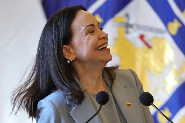 Venezuelan opposition leader Maria Corina Machado laughs as she delivers a speech after receiving the key to the city at the city hall in Santiago on March 12, 2026. Machado travelled to Chile to attend Chile's President Jose Antonio Kast's inauguration. (Photo by Javier TORRES / AFP)