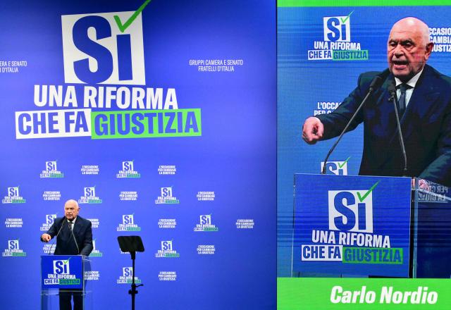 Italy's Justice Minister Carlo Nordio, speaks during a campaign meeting of Italian right wing party Brothers of Italy (Fratelli d'Italia) (Fdi) to support the "Yes" to Justice referendum, in Milan on March 12, 2026. (Photo by Stefano RELLANDINI / AFP)