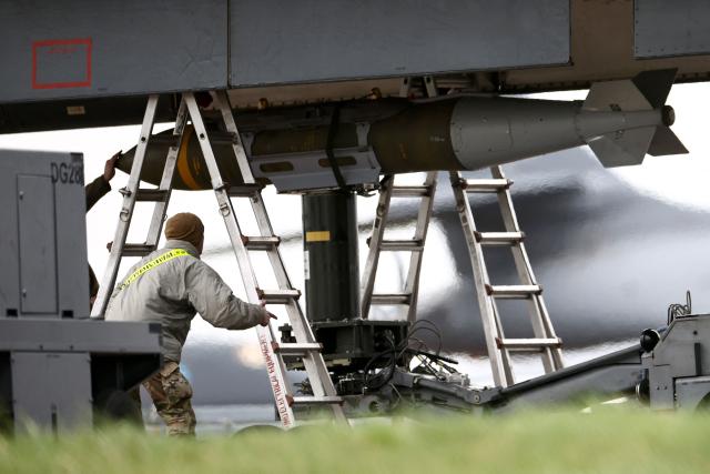 USAF military ground personnel prepare a Joint Direct Attack Munition (JDAM) for a US Air Force (USAF) B-1 Lancer bomber jet on the tarmac at RAF Fairford in south-west England on March 12, 2026. Fairford is one of two bases, along with the Diego Garcia facility in the Indian Ocean, that the UK has given the US permission to use for "specific defensive operations into Iran" to destroy Iranian missiles at source, the British defence minister said in a statement. (Photo by Henry NICHOLLS / AFP)