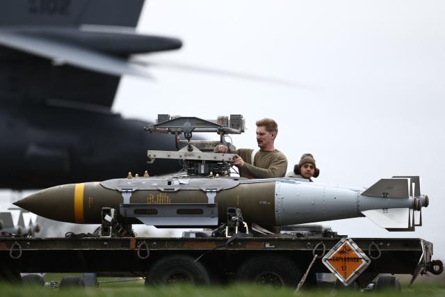 USAF military ground personnel prepare Joint Direct Attack Munitions (JDAM) for a US Air Force (USAF) B-1 Lancer bomber jet on the tarmac at RAF Fairford in south-west England on March 12, 2026. Fairford is one of two bases, along with the Diego Garcia facility in the Indian Ocean, that the UK has given the US permission to use for "specific defensive operations into Iran" to destroy Iranian missiles at source, the British defence minister said in a statement. (Photo by Henry NICHOLLS / AFP)