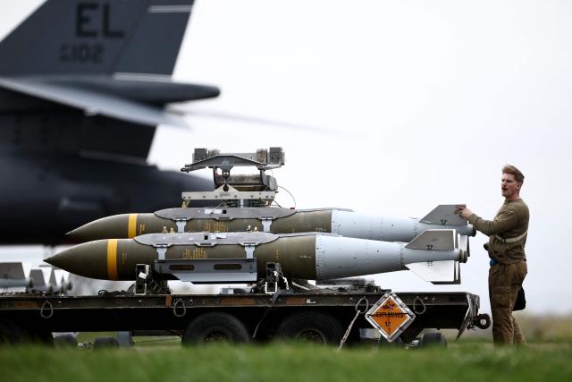 USAF military ground personnel prepare Joint Direct Attack Munitions (JDAM) for a US Air Force (USAF) B-1 Lancer bomber jet on the tarmac at RAF Fairford in south-west England on March 12, 2026. Fairford is one of two bases, along with the Diego Garcia facility in the Indian Ocean, that the UK has given the US permission to use for "specific defensive operations into Iran" to destroy Iranian missiles at source, the British defence minister said in a statement. (Photo by Henry NICHOLLS / AFP)