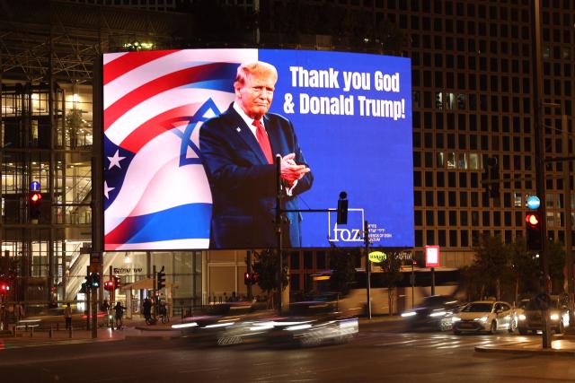 A billboard depicting an image of US President Donald Trump with a message thanking him, is displayed on the side of a building in the Israeli coastal city of Tel Aviv on March 12, 2026. On February 28, Israel and the United States launched strikes on Iran, killing its supreme leader Ayatollah and triggering a war that spread across the Middle East. (Photo by AFP) / 