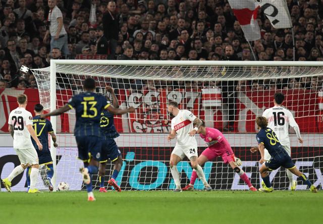 FC Porto's Portuguese midfielder #86 Rodrigo Mora (R) celebrates his 0-2 during the UEFA Europa League - Last 16 - first leg football match VfB Stuttgart v FC Porto in Stuttgart, southern Germany, on March 12, 2026. (Photo by THOMAS KIENZLE / AFP)
