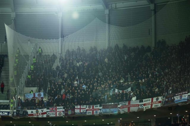 Aston Villa's supporters watch from the stands during the UEFA Europa League round of 16 first leg football match between Lille (LOSC) and Aston Villa  at the Pierre-Mauroy Stadium in Villeneuve-d'Ascq, northern France, on March 12, 2026. (Photo by Sameer AL-DOUMY / AFP)