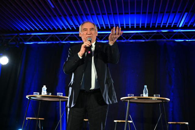 Outgoing Mayor of Pau and Modem (Mouvement democrate - Democratic Movement) candidate for re-election Francois Bayrou gestures as he addresses the audience during a campaign rally in Pau, southwestern France on March 12, 2026, ahead of France's municipal elections. French voters are scheduled to head to the polls for municipal elections on March 15 and March 22, 2026. (Photo by GAIZKA IROZ / AFP)