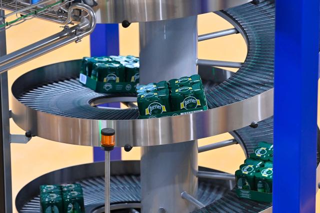 This photograph shows cans on the production line of Perrier's natural sparkling mineral water factory in Vergeze, southern France, on March 12, 2026. (Photo by Sylvain THOMAS / AFP)