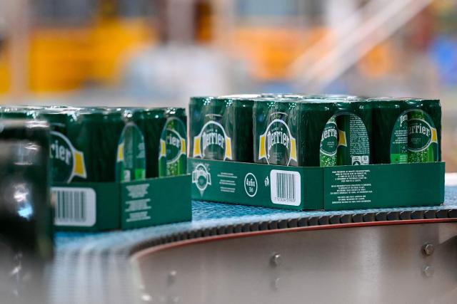 This photograph shows can packages on the production line of Perrier's sparkling mineral water factory in Vergeze, southern France, on March 12, 2026. (Photo by Sylvain THOMAS / AFP)