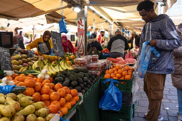 A man buys fruit at the market in Noailles neighbourhood of Marseille, southern France, on March 12, 2026. (Photo by Elodie CLEMENT / AFP)