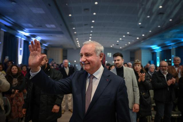 Toulouse outgoing mayor and candidate to succession Jean-Luc Moudenc waves to people as he arrives to address a campaign meeting in Toulouse on March 12, 2026, three days ahead of the first round of France's municipal elections. French voters head to the polls for municipal elections on March 15 and 22, 2026. (Photo by Ed JONES / AFP)