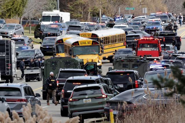 TOPSHOT - Law enforcement responds at the scene of a shooting on Walnut Lake Rd, outside of Temple Israel synagogue, in West Bloomfield, Michigan, a suburb of Detroit, on March 12, 2026. An unidentified shooter was killed on March 12 after exchanging gunfire with security in an attack on a synagogue in the outskirts of Detroit, Michigan, police said. Police said the gunman was dead following the attack on the Temple Israel synagogue in West Bloomfield. (Photo by JEFF KOWALSKY / AFP)