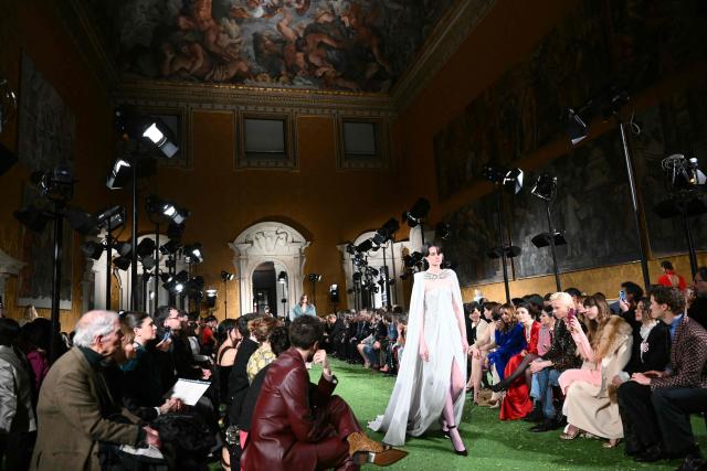 A model presents a creation by Italian fashion house Valentino during the show "Interferenze" Fall/Winter 2026-2027 collection at Palazzo Barberini in Rome on March 12, 2026. Italian fashion house Valentino returns to its roots with a catwalk show designed by creative director Alessandro Michele in one of Rome's most spectacular venues, two months after the death of founder Valentino Garavani. (Photo by Alberto PIZZOLI / AFP)