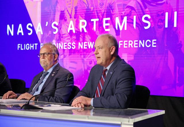 Shawn Quinn (L), manager, Exploration Ground Systems Program looks on as Norm Knight, director, Flight Operations Directorate addresses the media about revisions and fixes being done to numerous Artemis II rocket components at the Kennedy Space Center in Cape Canaveral, Florida, on March 12, 2026. NASA rolled the massive Space Launch System rocket and Orion spacecraft back to the Vehicle Assembly Building from Launch Pad 39B on February 25 to troublshoot problems encountered during a wet dress rehearsal. NASA engineers and technicians will effect repairs and replace numerous flight batteries prior to sending four astronauts to the moon for the first time in more than 50 years. Artemis II is scheduled to launch in April. (Photo by Gregg Newton / AFP)