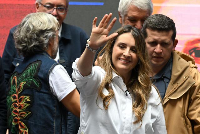Colombia's presidential candidate for the conservative Democratic Centre party, Paloma Valencia, waves to supporters during the presentation of her running mate Juan Daniel Oviedo in Bogota on March 12, 2026. Colombia will hold presidential elections on May 31st. (Photo by Raul ARBOLEDA / AFP)