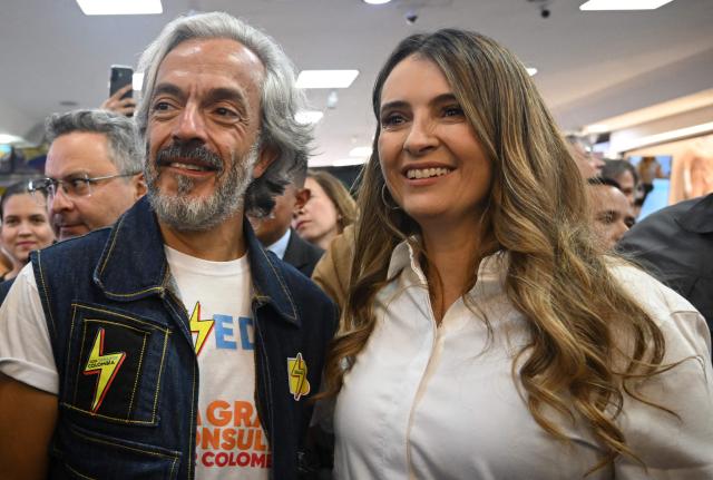 Colombia's presidential candidate for the conservative Democratic Centre party, Paloma Valencia (R), and vice-presidential candidate Juan Daniel Oviedo (L) pose for a photo during his presentation as running mate in Bogota on March 12, 2026. Colombia will hold presidential elections on May 31st. (Photo by Raul ARBOLEDA / AFP)