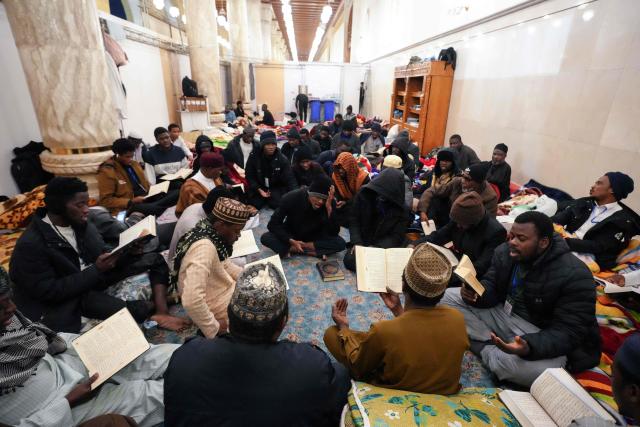 Shia Muslim faithful, including Iranian visitors and others, participate in the ritual of Itikaf, or spiritual retreat, at the Kufa Mosque, taking advantage of the days and nights of Laylat al-Qadr, or the Night of Destiny, one of the holiest nights during the fasting month of Ramadan, to pray in the holy city of Kufa, south of the Iraqi capital Baghdad, on March 12, 2026. (Photo by Qassem al-KAABI / AFP)