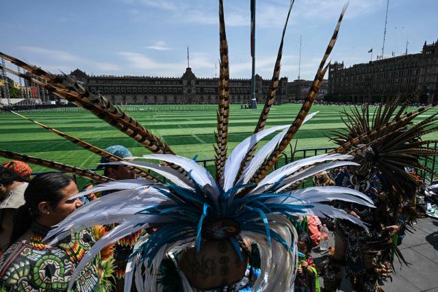 An Indigenous woman participates in a ceremony at the Zocalo square covered in artificial turf, where Mexicans will attempt to break the Guinness World Record for the largest soccer class in the world next weekend, in Mexico City on March 12, 2026. (Photo by Yuri CORTEZ / AFP)