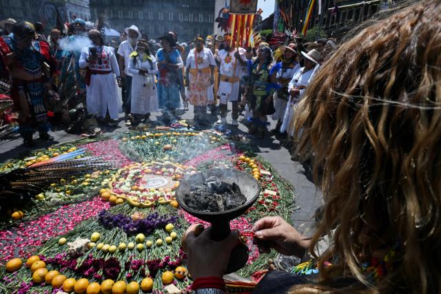 A group of indigenous people participate in a ceremony to celebrate the beginning of the Aztec year—known as "Xiuhpohualli"—which marks the start of the agricultural and solar cycle, in Mexico City on March 12, 2026. (Photo by Yuri CORTEZ / AFP)