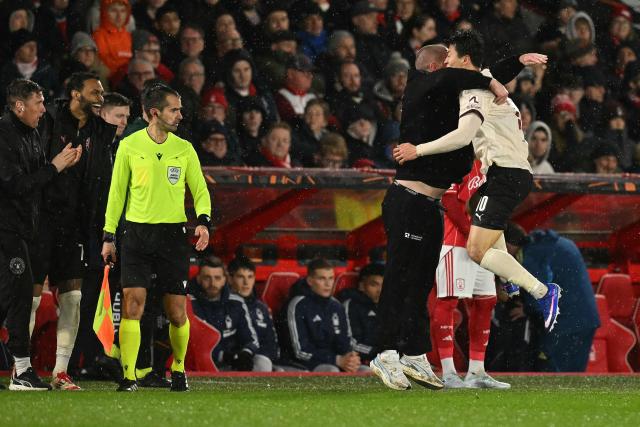 Midtjylland's South Korean forward #10 Gue-sung Cho (R) celebrates scoring the opening goal with Midtjylland's Danish coach Mike Tullberg during the UEFA Europa League round of 16, first leg football match between Nottingham Forest and FC Midtjylland at The City Ground in Nottingham, central England, on March 12, 2026. (Photo by Oli SCARFF / AFP)