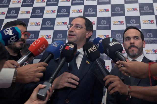 Jose Manuel Restrepo, running mate of Colombia's presidential candidate Abelardo de la Espriella (R), speaks to reporters during the presentation of their ticket at the Cali registration office in Cali, Colombia, on March 12, 2026. (Photo by Joaquin SARMIENTO / AFP)