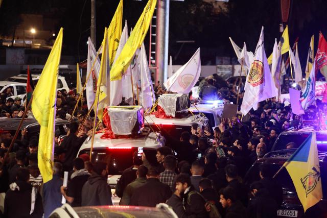 People take part in a funeral procession of members of pro-Iran armed factions in Al?Qaim, a border town in western Iraq near Syria, on March 12, 2026. Armed groups and officials have said at least 37 people have been killed in Iraq since the start of the Middle East war, according to an AFP tally based on their announcements. Pro-Iran armed factions and security sources say 32 Iran-backed fighters were killed in strikes they blame on the United States and Israel. (Photo by Murtaja LATEEF / AFP)