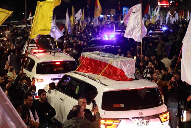 People take part in a funeral procession of members of pro-Iran armed factions in Al?Qaim, a border town in western Iraq near Syria, on March 12, 2026. Armed groups and officials have said at least 37 people have been killed in Iraq since the start of the Middle East war, according to an AFP tally based on their announcements. Pro-Iran armed factions and security sources say 32 Iran-backed fighters were killed in strikes they blame on the United States and Israel. (Photo by Murtaja LATEEF / AFP)