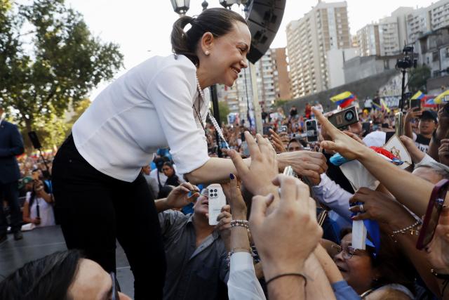 TOPSHOT - Venezuelan opposition leader Maria Corina Machado greets members of the Venezuelan community in Chile at Almagro Square in Santiago on March 12, 2026. Machado travelled to Chile to attend Chile's President Jose Antonio Kast's inauguration. (Photo by Raul BRAVO / AFP)